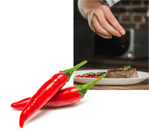 A photo of a chef’s hand adding spices to a plated dish of steak and grilled vegetables, overlayed by an image of two fresh Calabrian chili peppers.